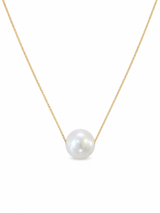 Pearl necklace on a gold chain against a white background
