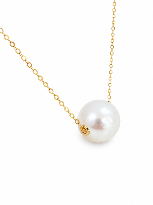 Pearl necklace with gold chain on a white background