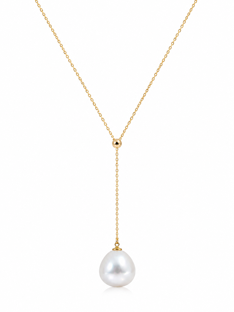 Gold necklace with a single pearl pendant on a white background