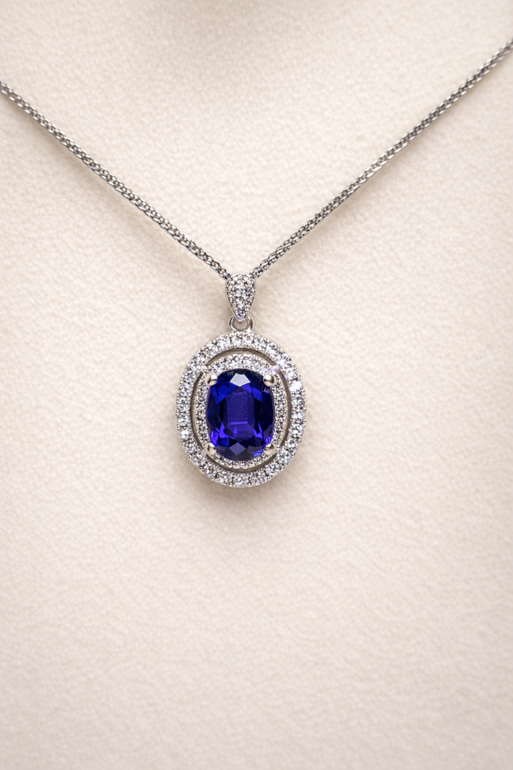 0.887ct blue sapphire and diamond halo pendant