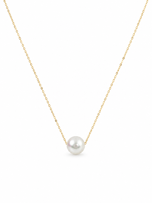 Pearl necklace on a gold chain against a white background