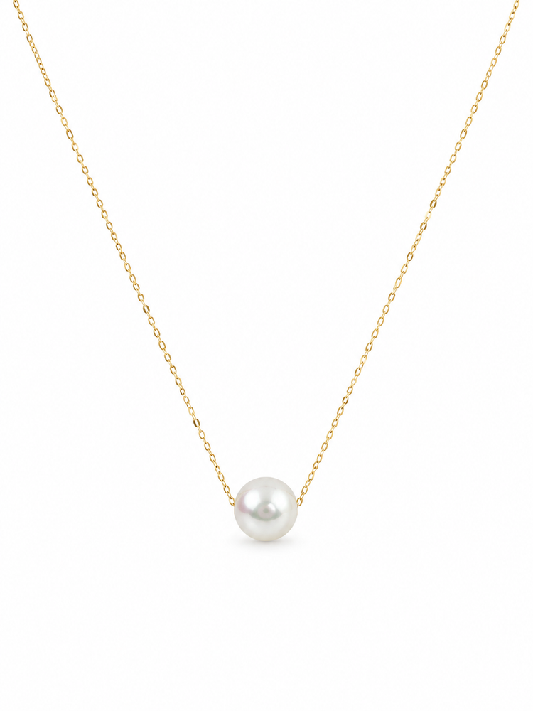 Pearl necklace on a gold chain against a white background