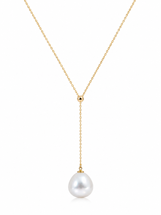 Gold necklace with a single pearl pendant on a white background